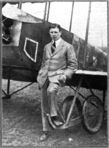 Mr. C. W. Graham standing in front of the lower wing of his biplane, "Lizzie". -- Photo Credit:  Flight, April 9, 1915