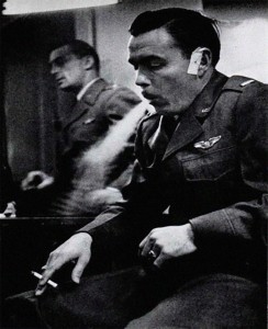 Visibly shaken, Lt. Warren Brown, USAFE, smokes a cigarette; his bandaged ear is a minor injury sustained while ejecting from the F-84E.  In the background is Lt. Donald Smith, USAFE, his wingman that day, who returned to base safely.