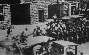 The Oklahoma National Guard arrives in Tulsa; the truck that mounted a machinegun is seen in the lower left of this rare and unique photograph.
